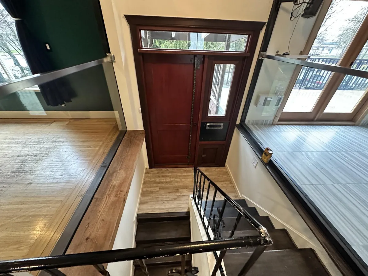 Original front door and stairway interior before renovation