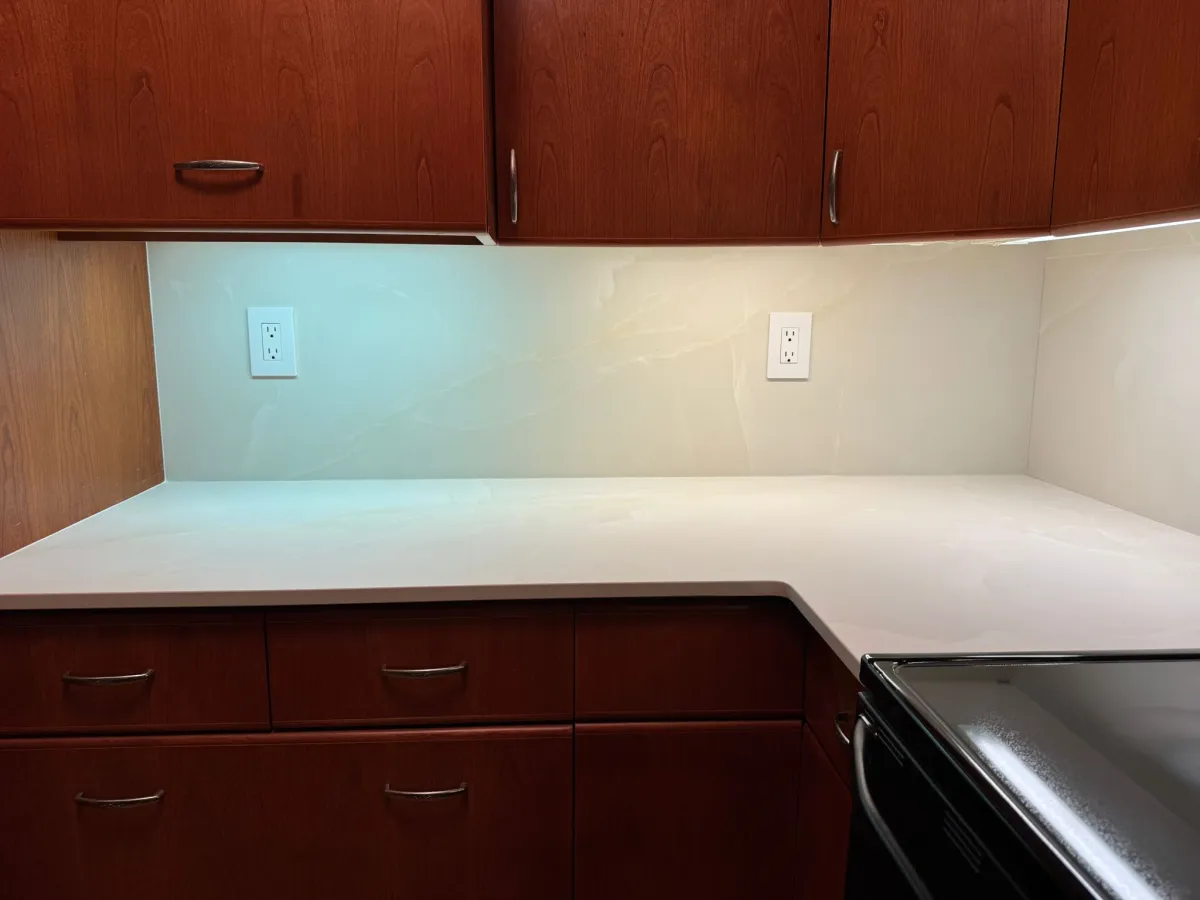 Completed quartz countertop with matching backsplash in corner section