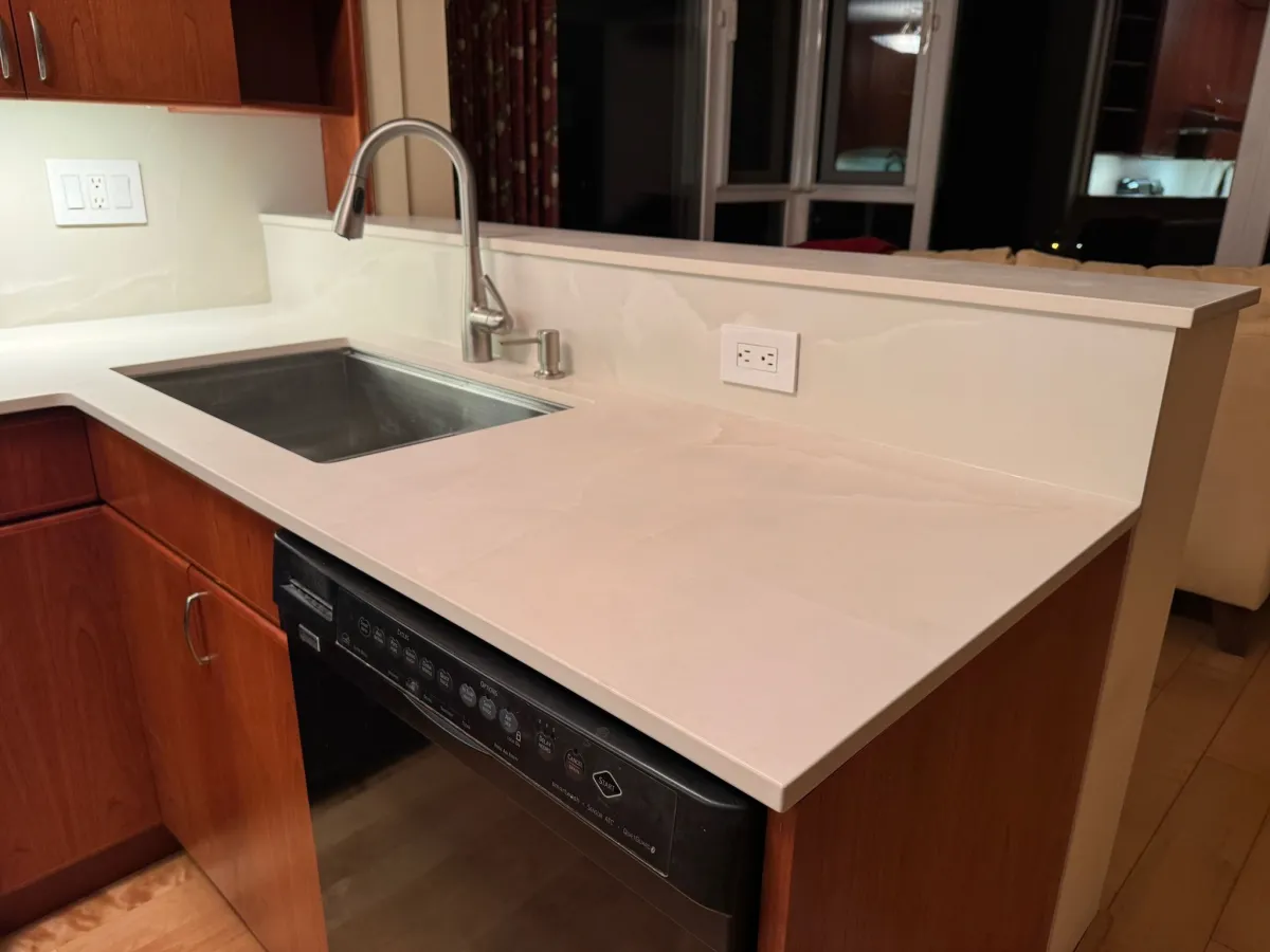 Completed kitchen island with new quartz countertop, sink and faucet