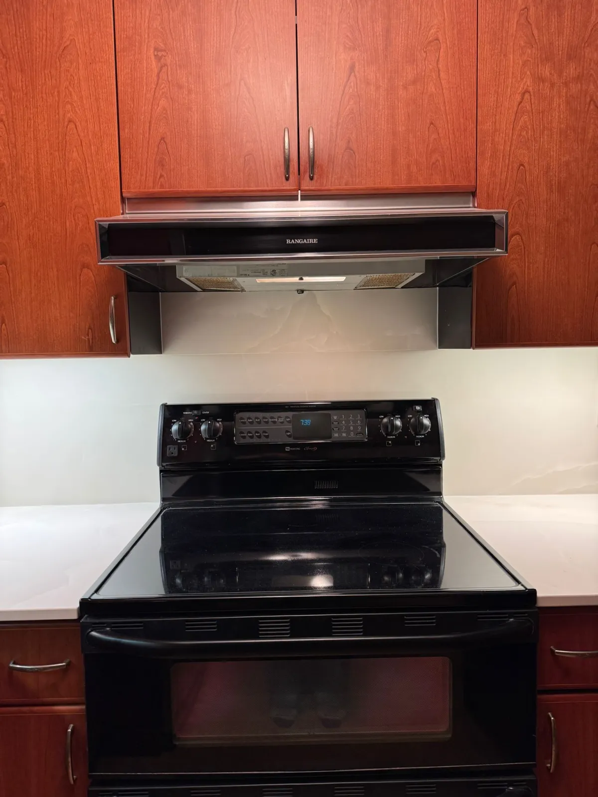 Completed countertop around stove area with quartz backsplash