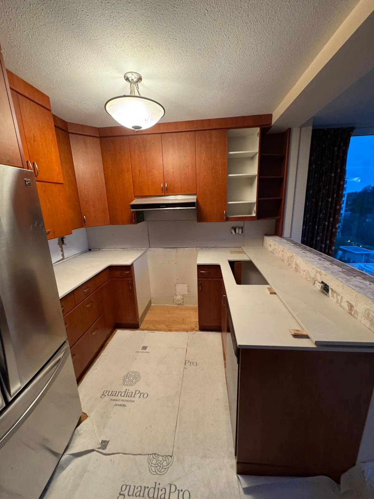 New quartz countertops being installed with floor protection