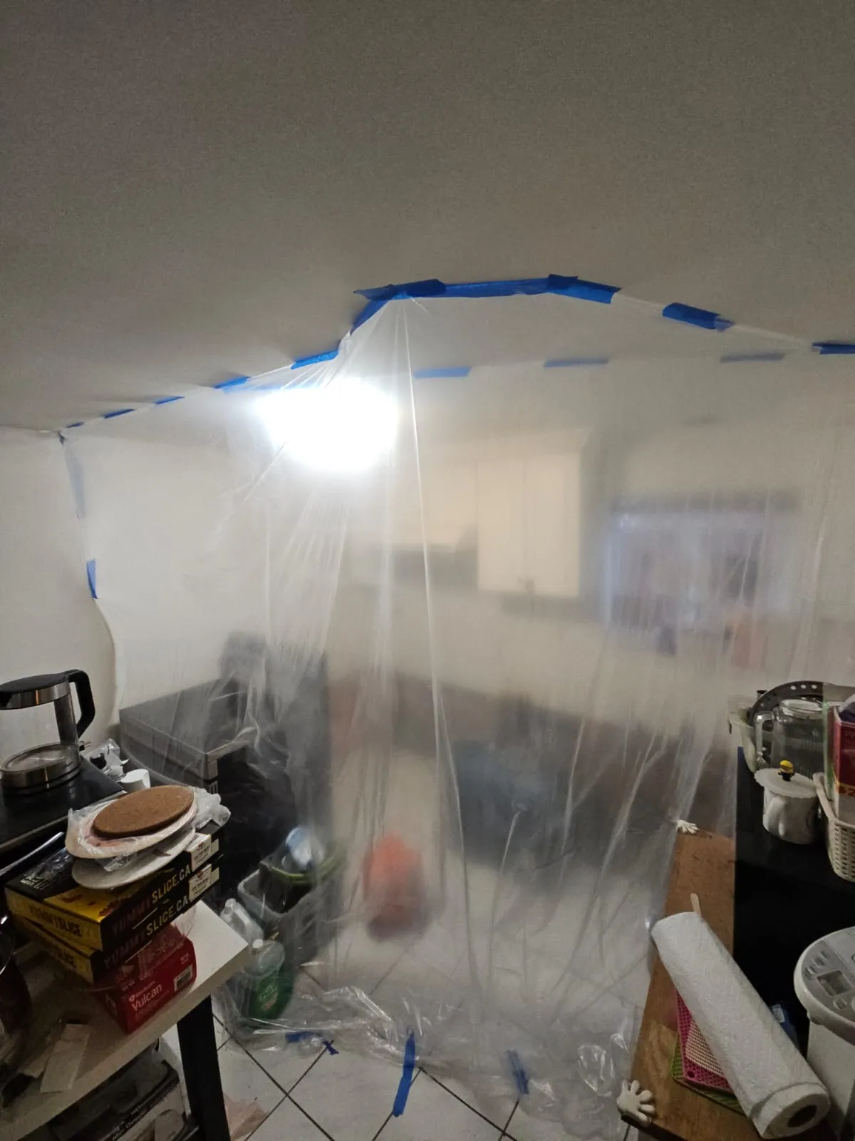 Plastic containment barrier set up during kitchen renovation