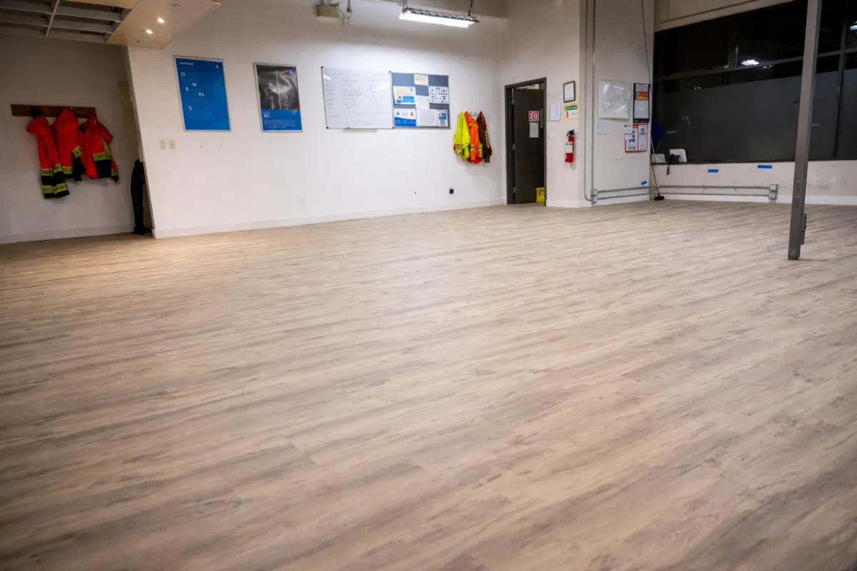 Large warehouse main floor with new wood-look vinyl plank flooring installed