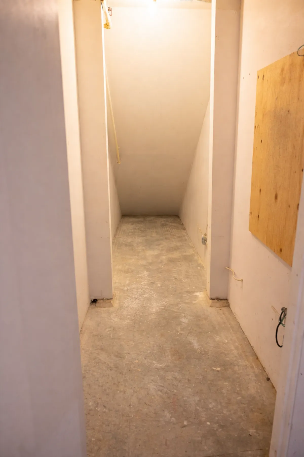 Warehouse hallway with bare concrete floor before flooring installation
